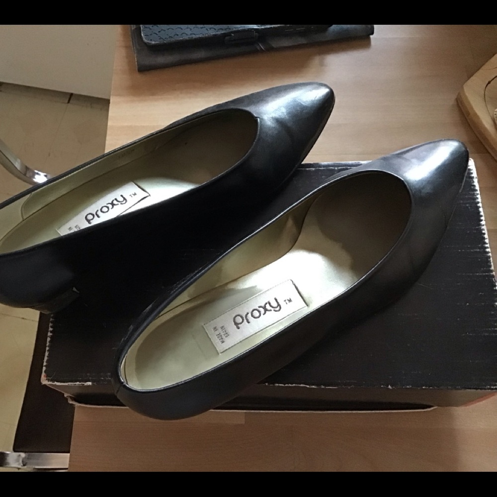Black low heel shoes, which is slightly warn.  Heel of the shoes is gold plated.